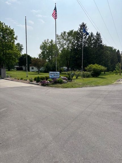 An American flag and a blue sign for "Valley View Park" stand in a grassy area at an intersection.