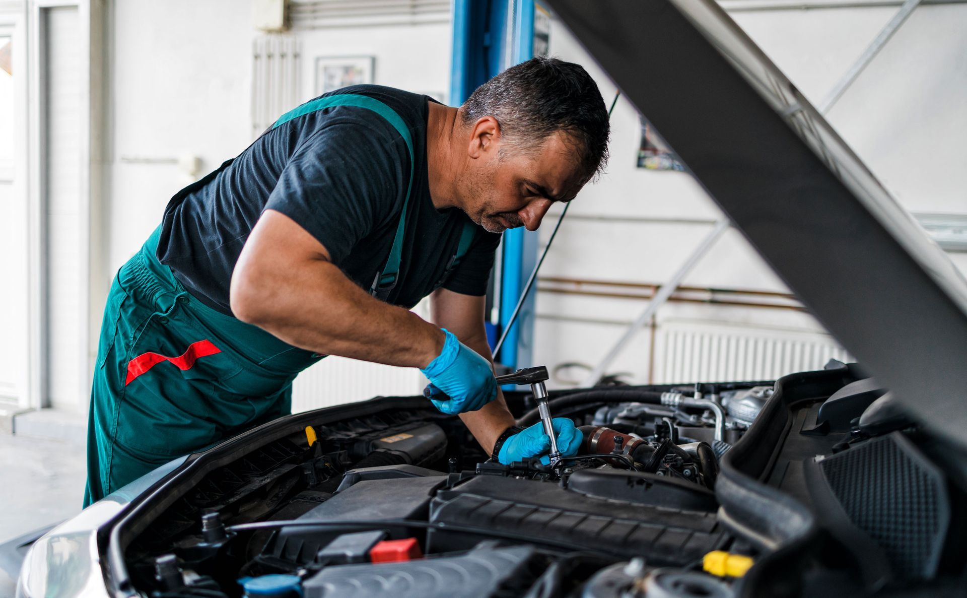 Man Fixing A Car | Brainard, NE | CTF Service Inc