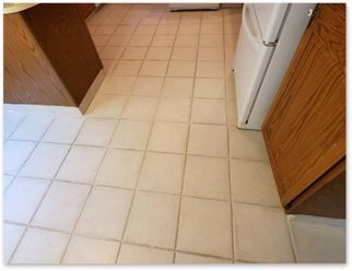 A kitchen with white tile floors and brown cabinets