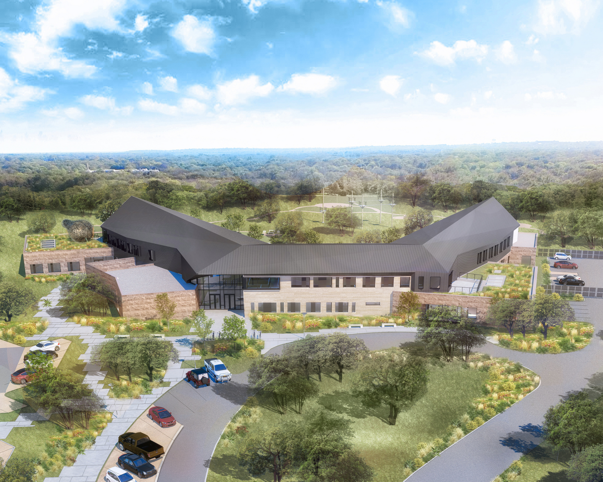 A man wearing a hat and apron is standing in front of a grill.