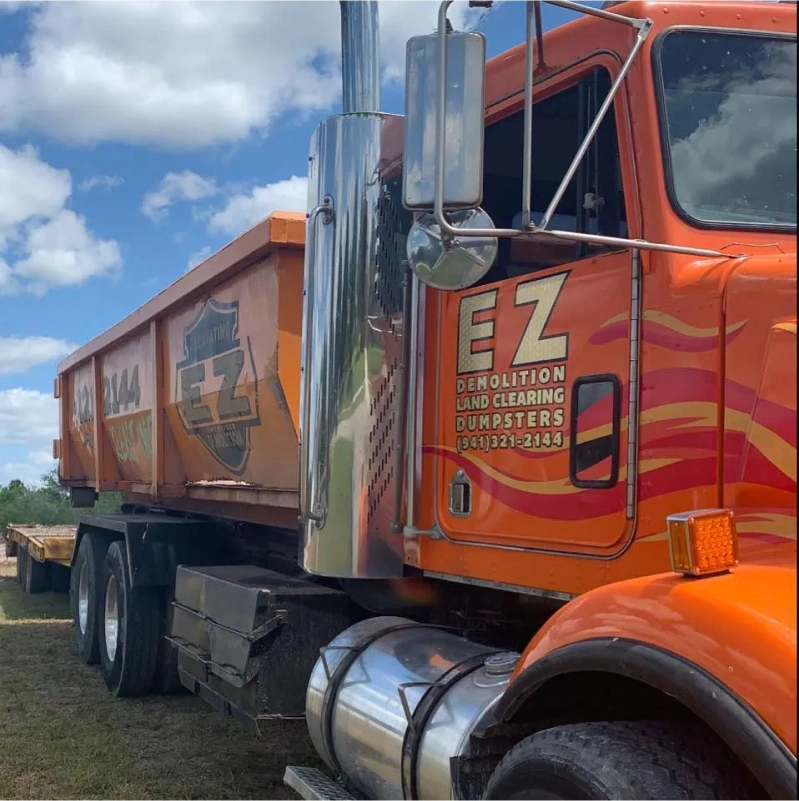 Orange semi-truck with a dumpster, labeled 