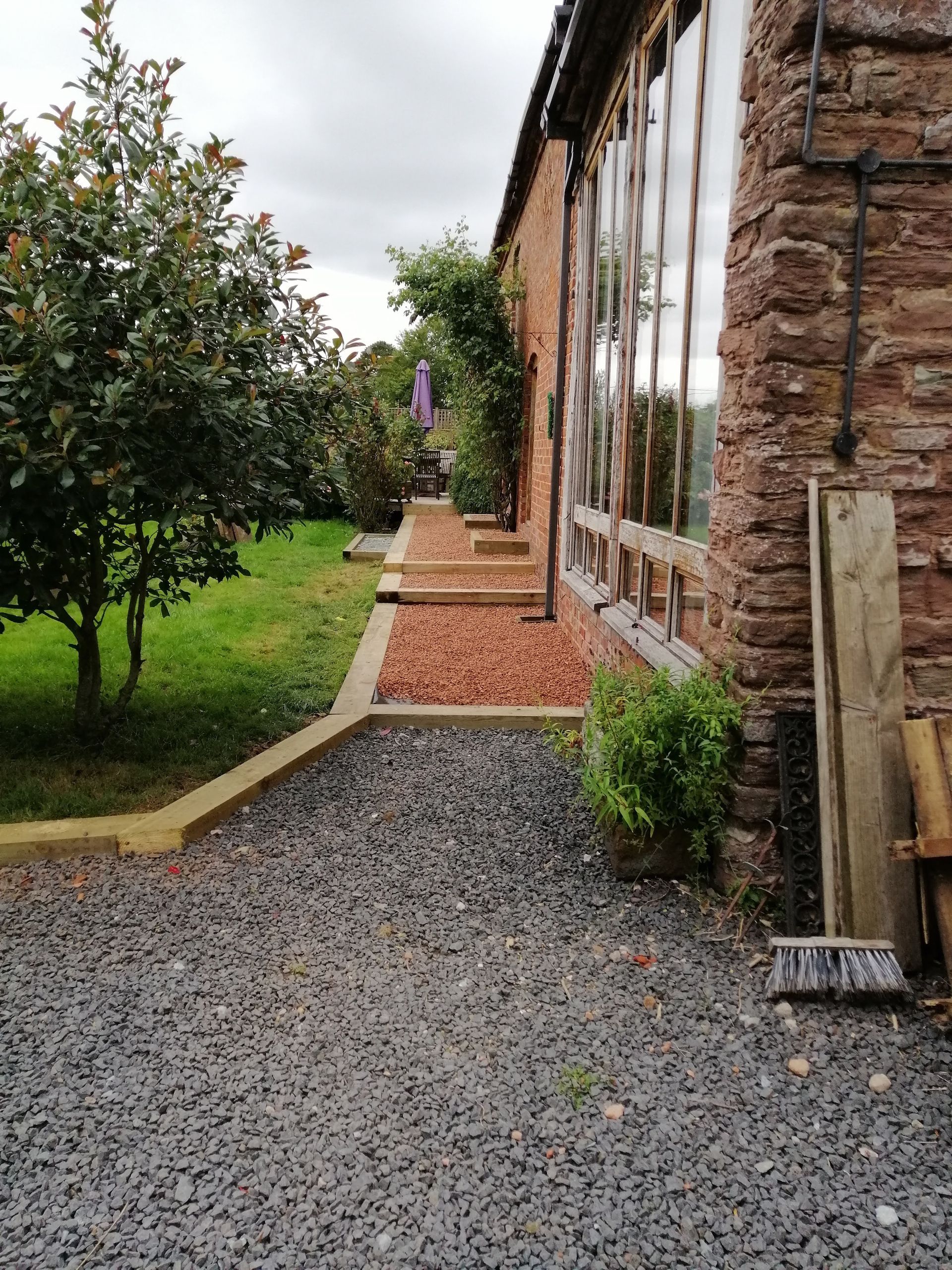 A gravel path leading to a brick building