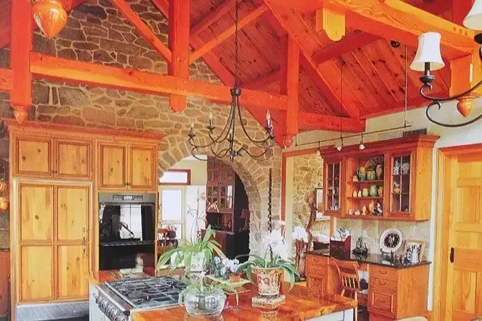 Kitchen With Wooden Cabinets and a Stone Wall — Payless Timbers in Tolga, QLD