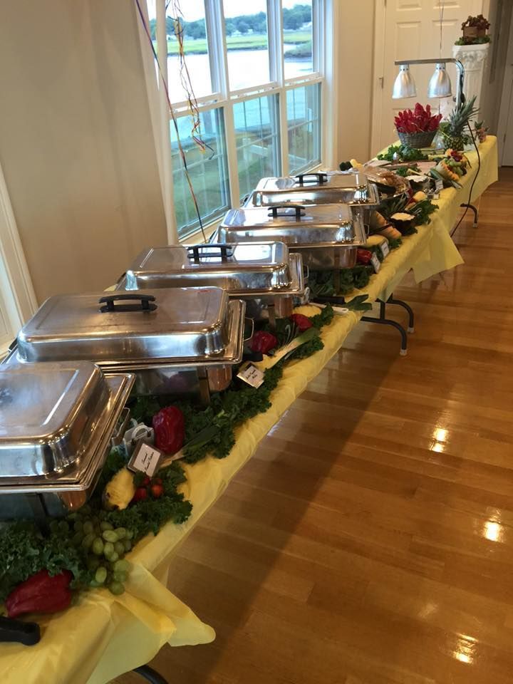 A long buffet table with a lot of food on it.