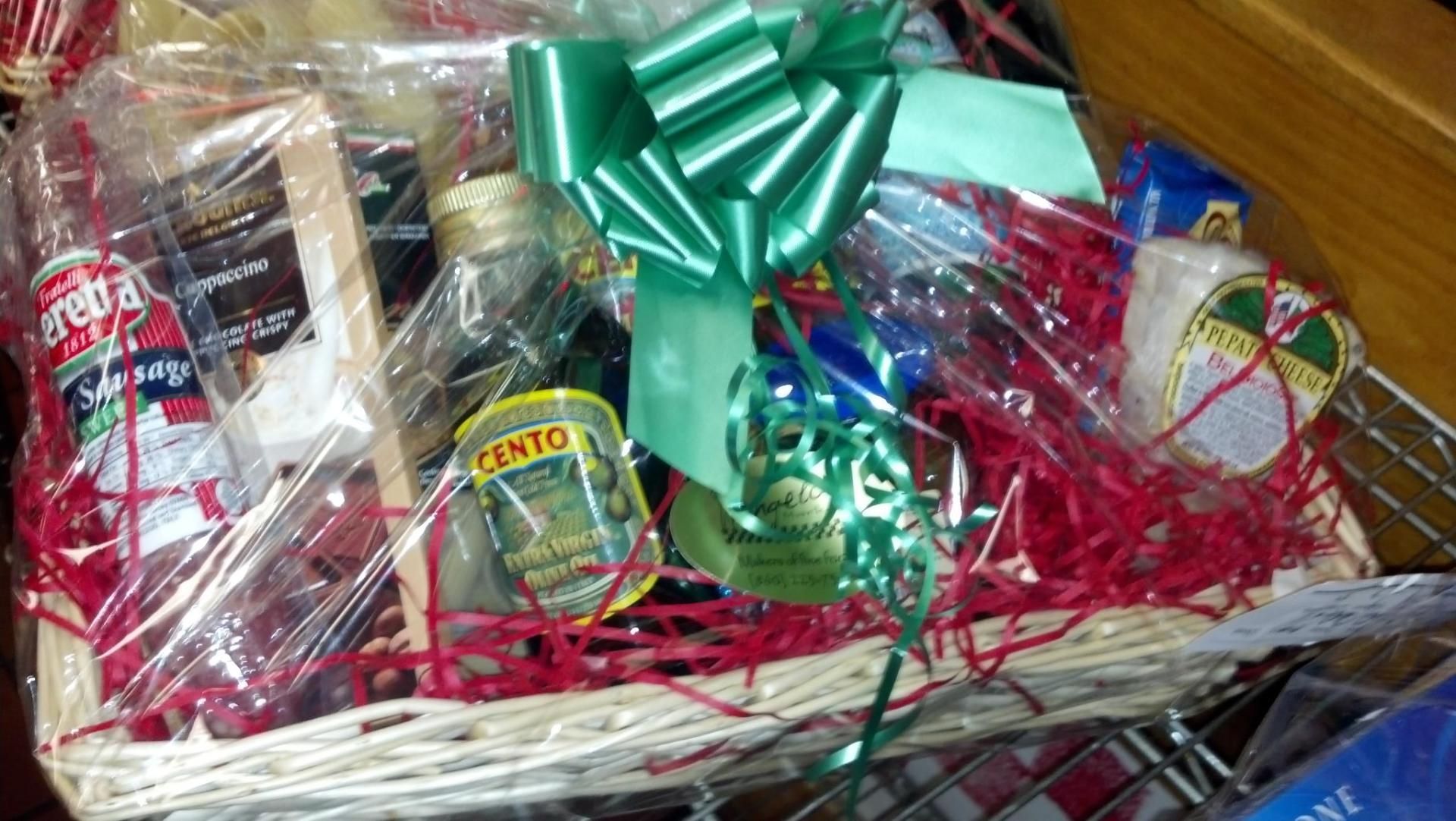 A gift basket filled with food and a green bow