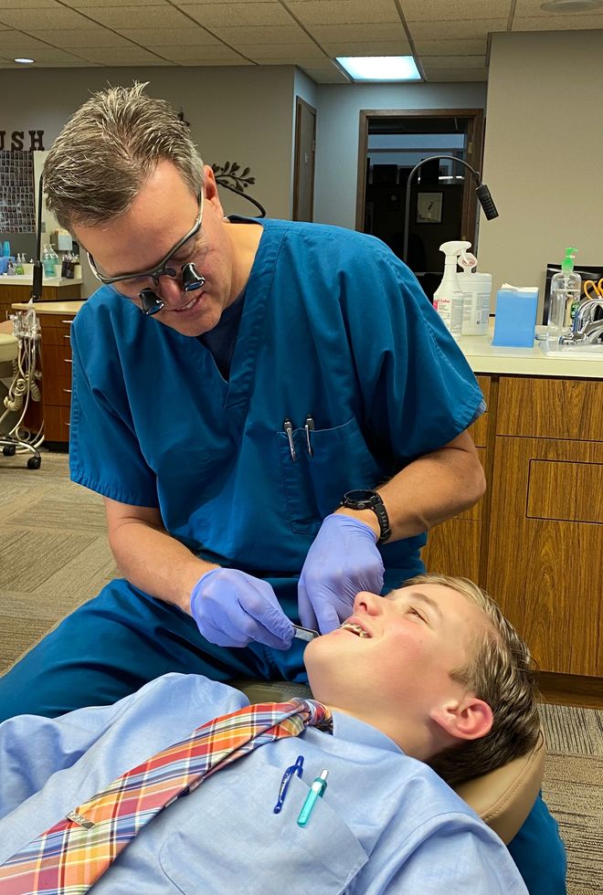 Dr. Thomas Borgula working in his office with a patient