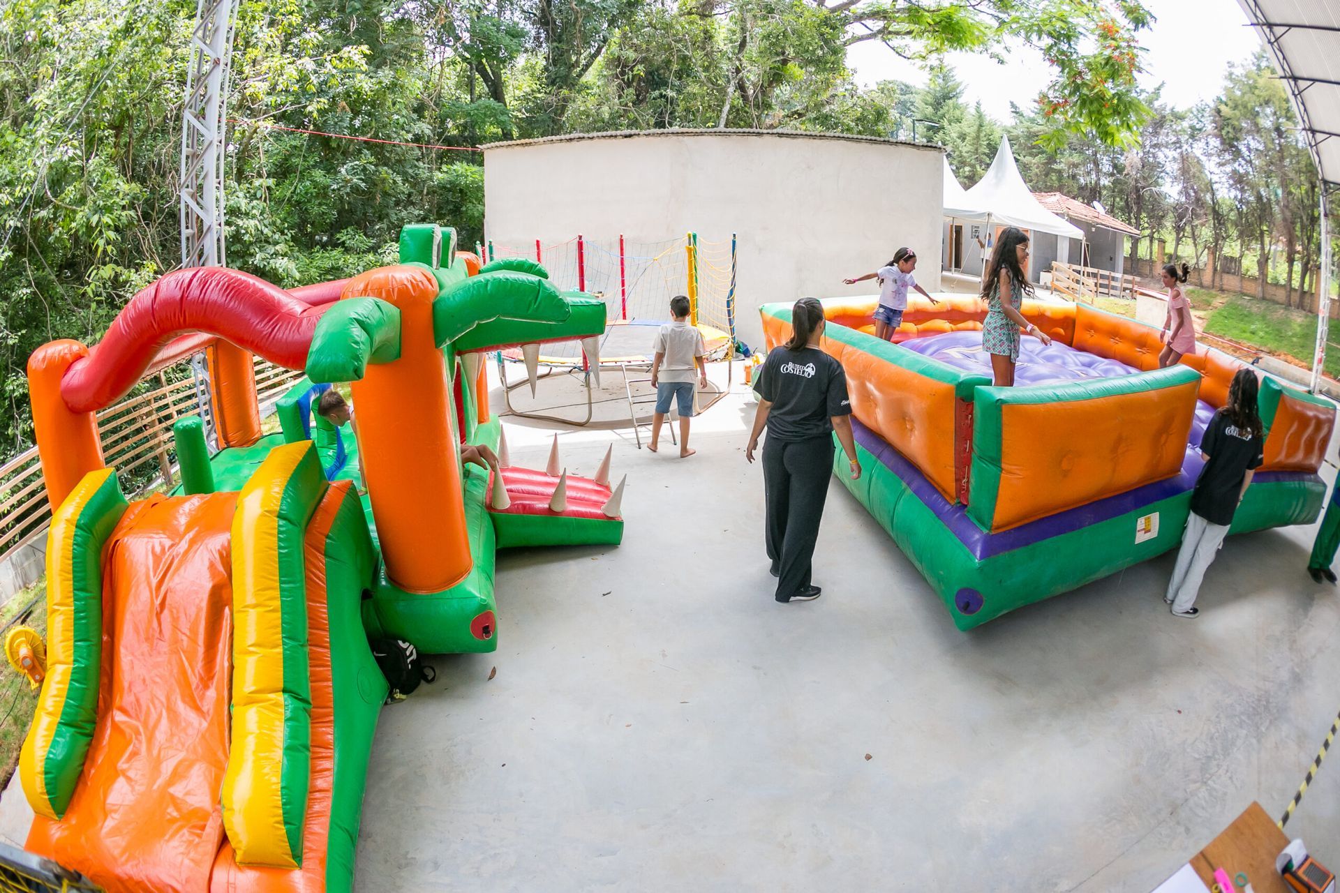 Um grupo de crianças está brincando em um playground inflável.