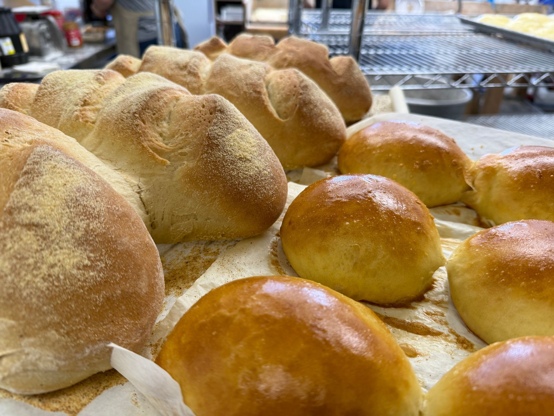 A bunch of bread and rolls are sitting on a table.