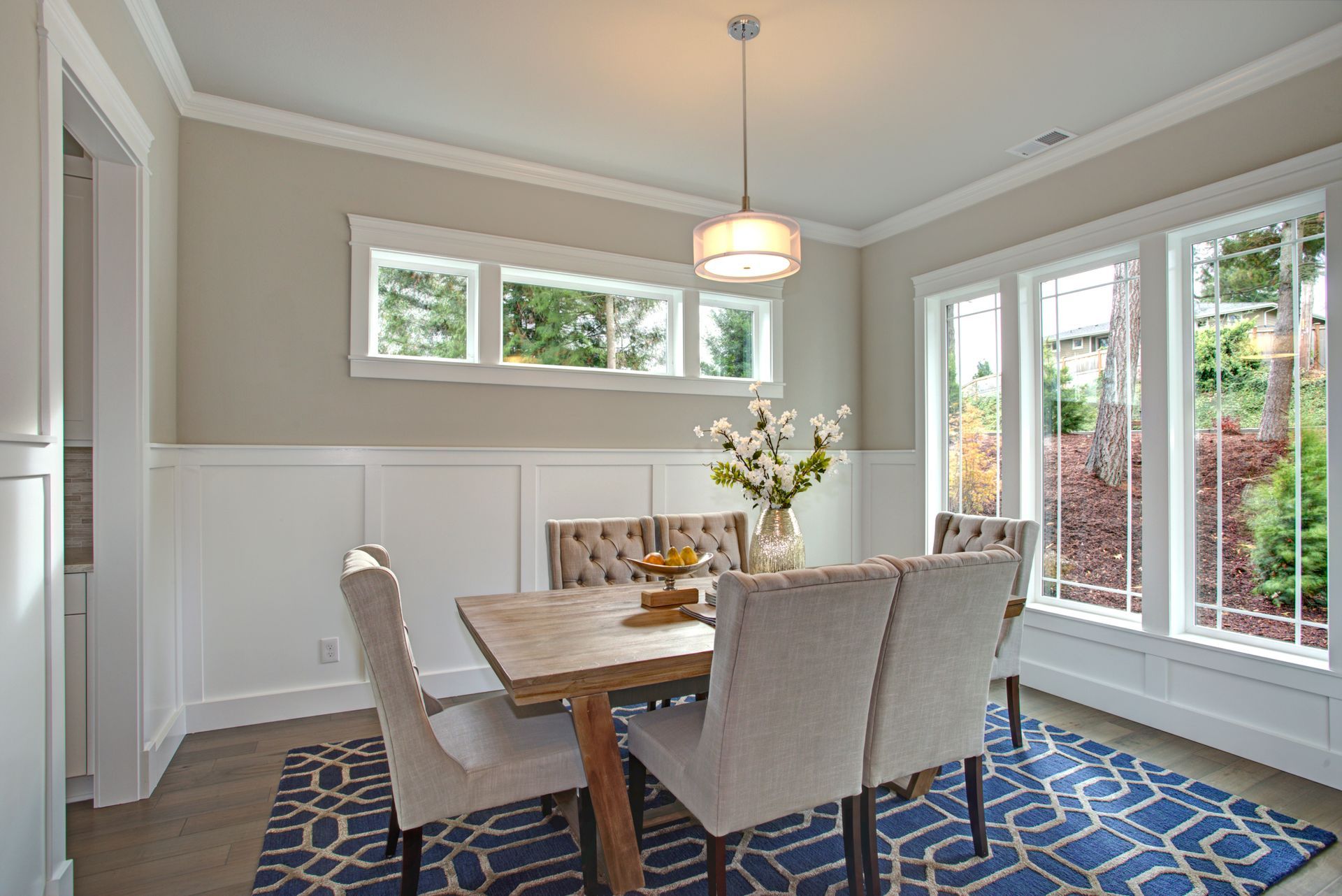 A modern dining room with various window sizes