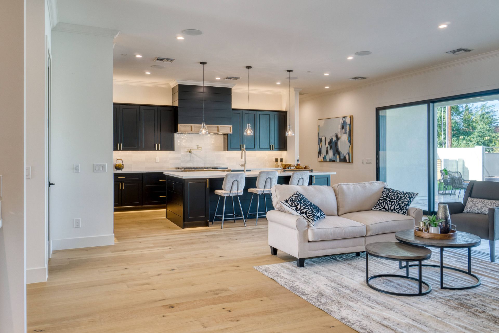 An open concept kitchen and living room in a modern style at Beginning To End Interiors near  Saraso