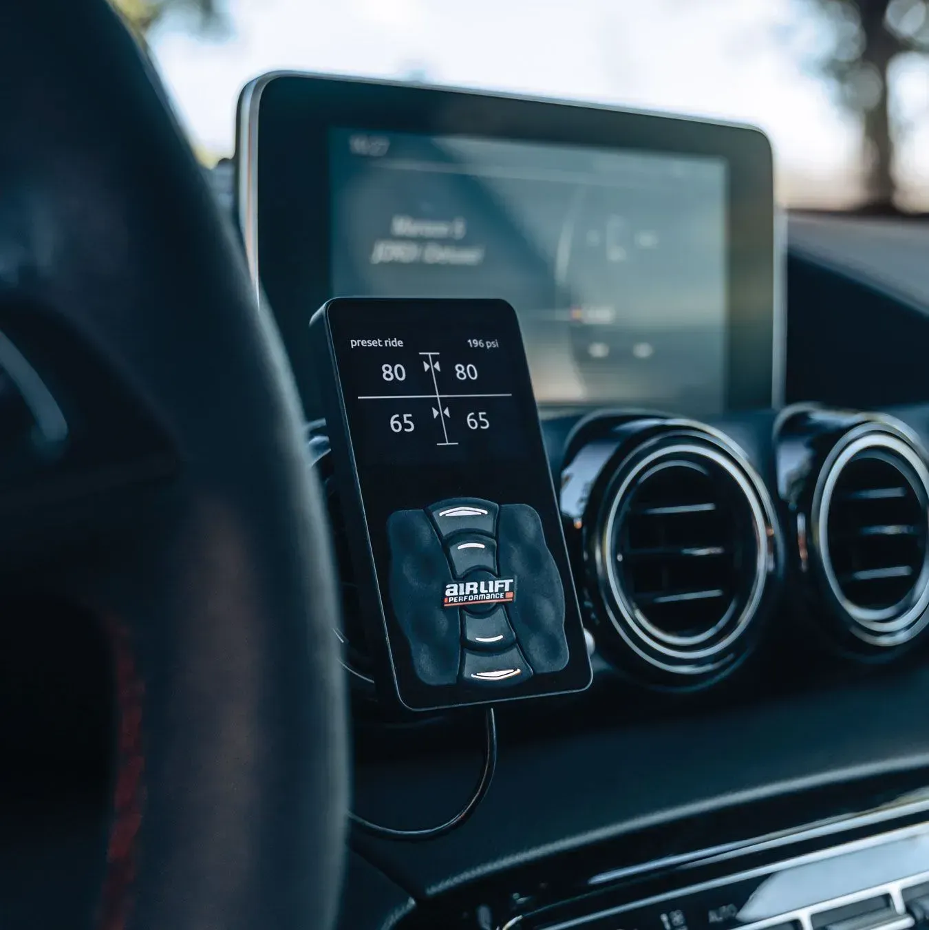 Black car interior with a small display showing tire pressure.