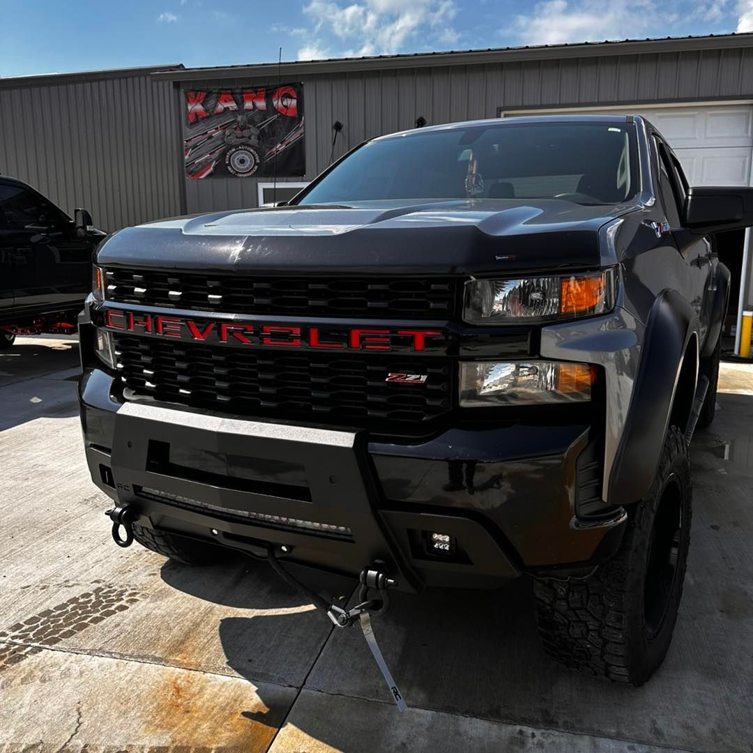 Black Chevrolet Silverado truck with a red 