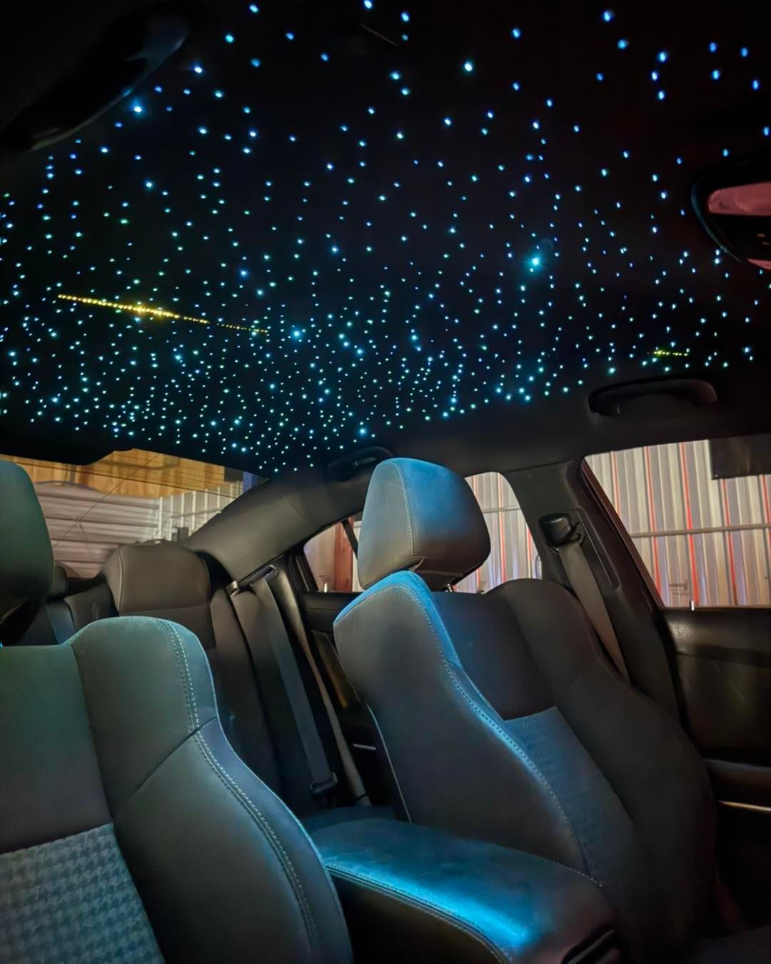 Black car interior with starry night fiber optic ceiling.