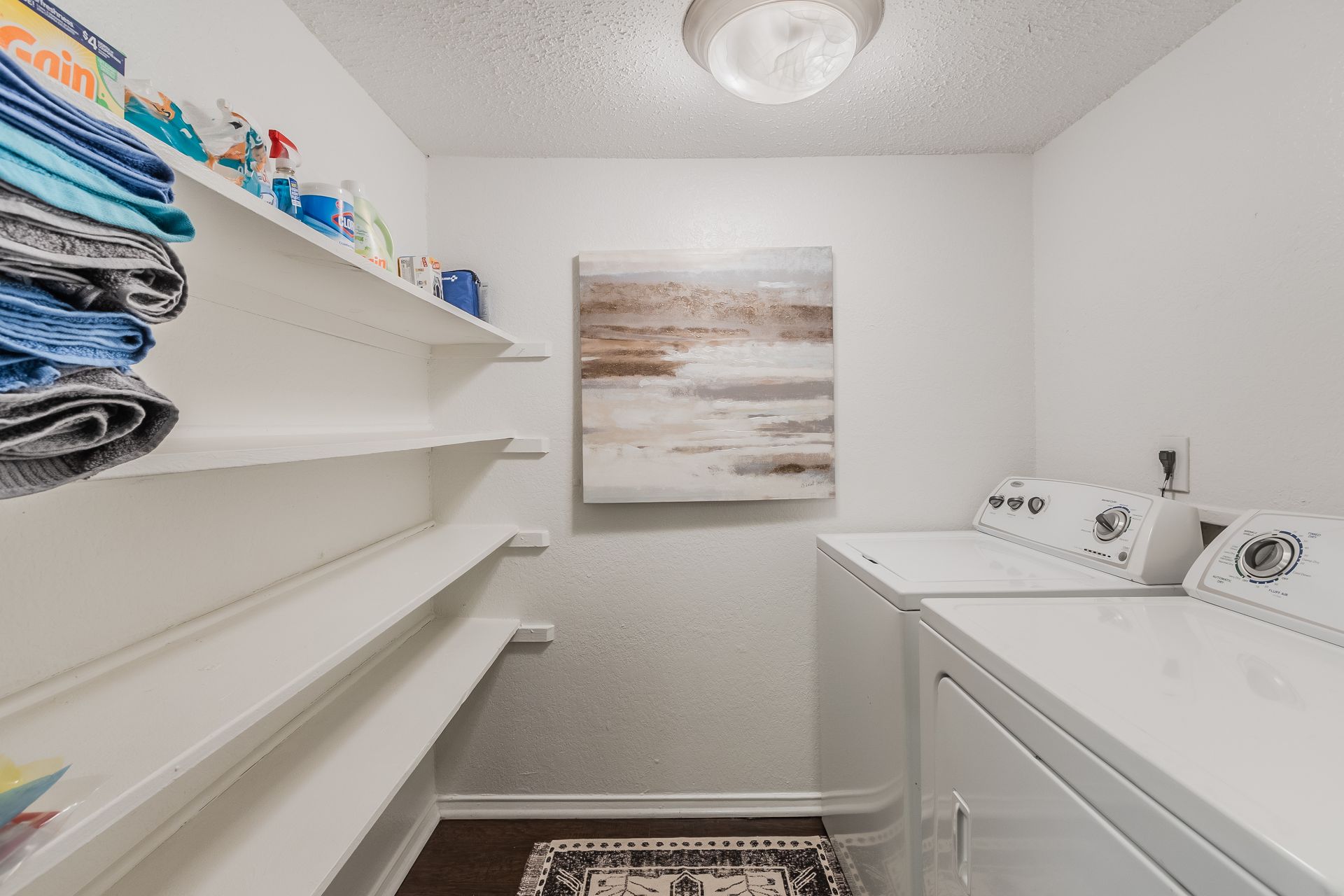 Photo of a laundry area with plenty of shelves behind