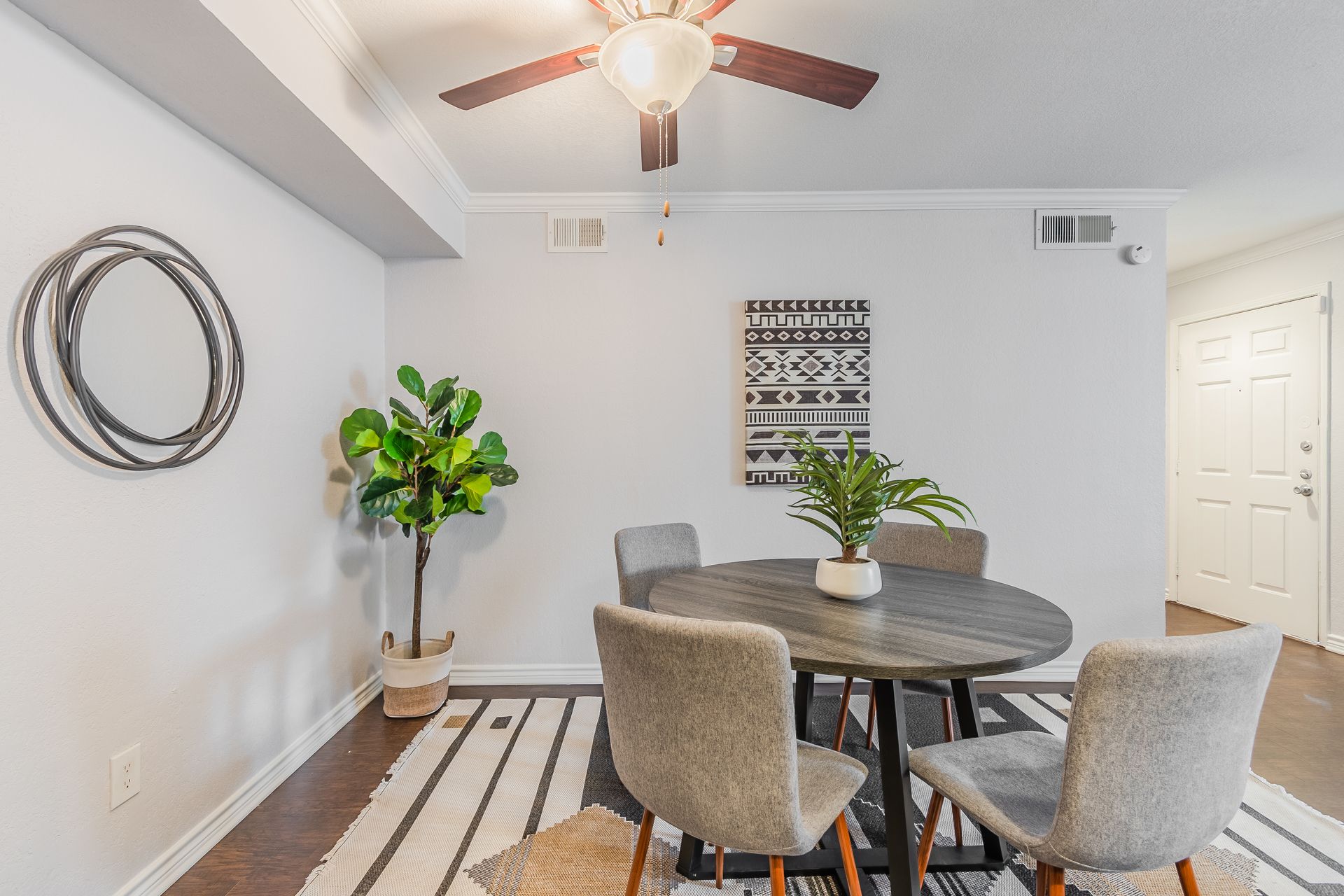 Photo of a dining area with a hallway in the background
