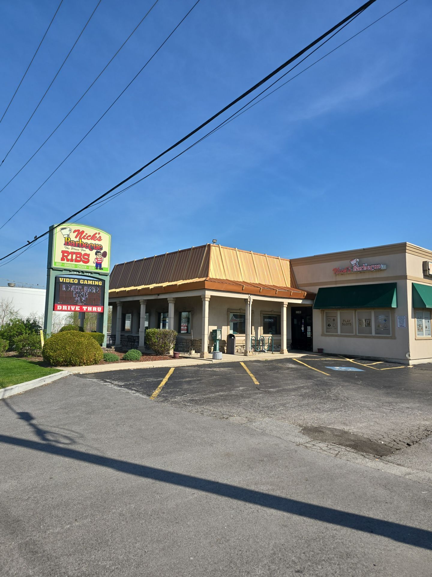 Person in workwear applying black sealant to a concrete surface.