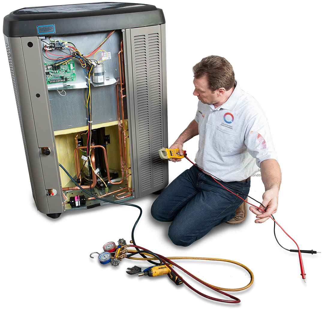 A man is kneeling down in front of an air conditioner