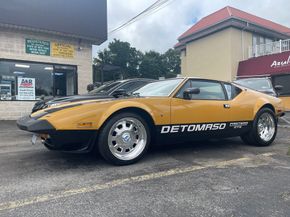 Yellow and black De Tomaso Pantera sports car parked outside a business.  | A & R Auto Repair