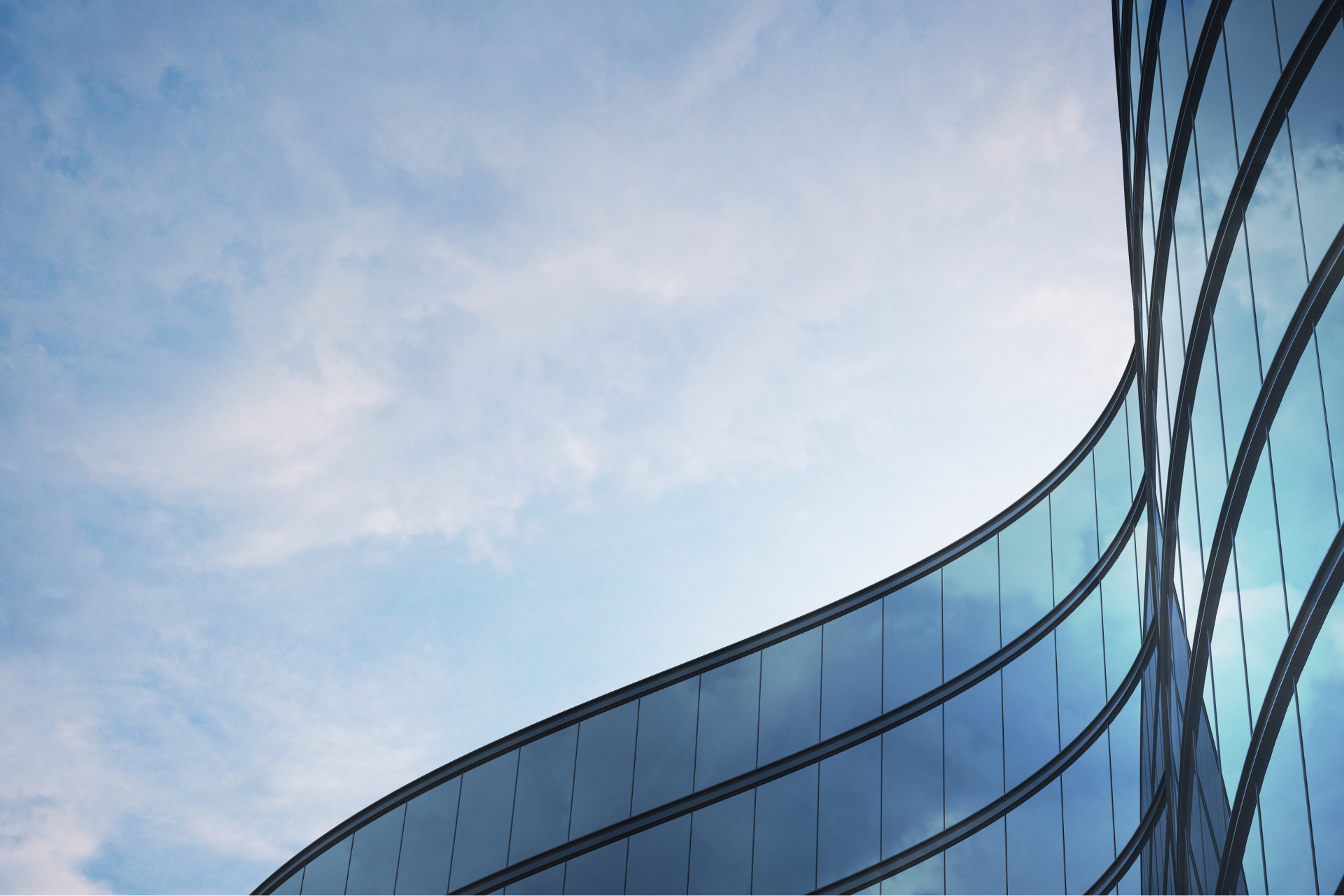 A building with a lot of windows and a blue sky in the background