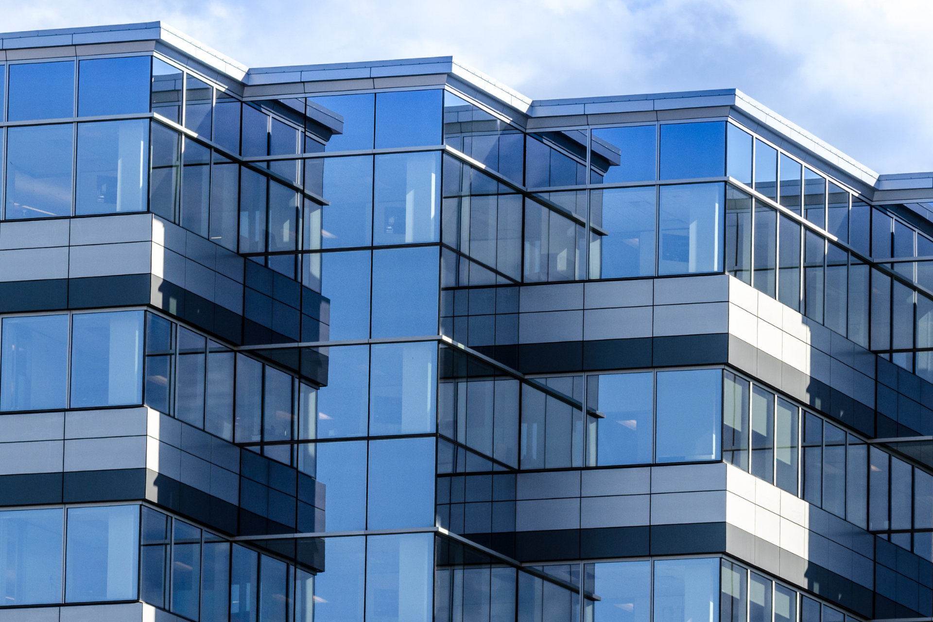 A building with a lot of windows and a blue sky in the background