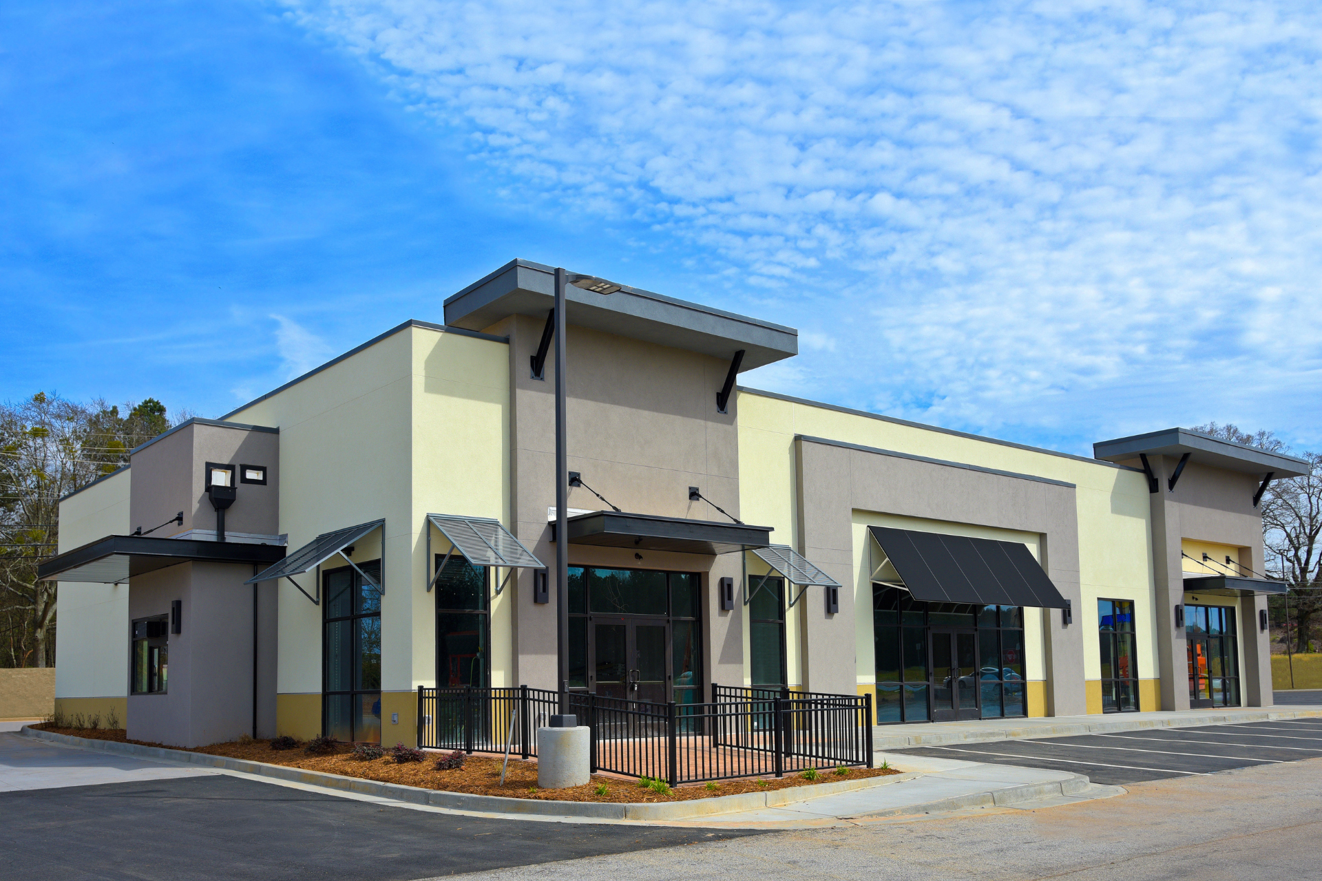 A large building with a lot of windows and awnings on the side of it.