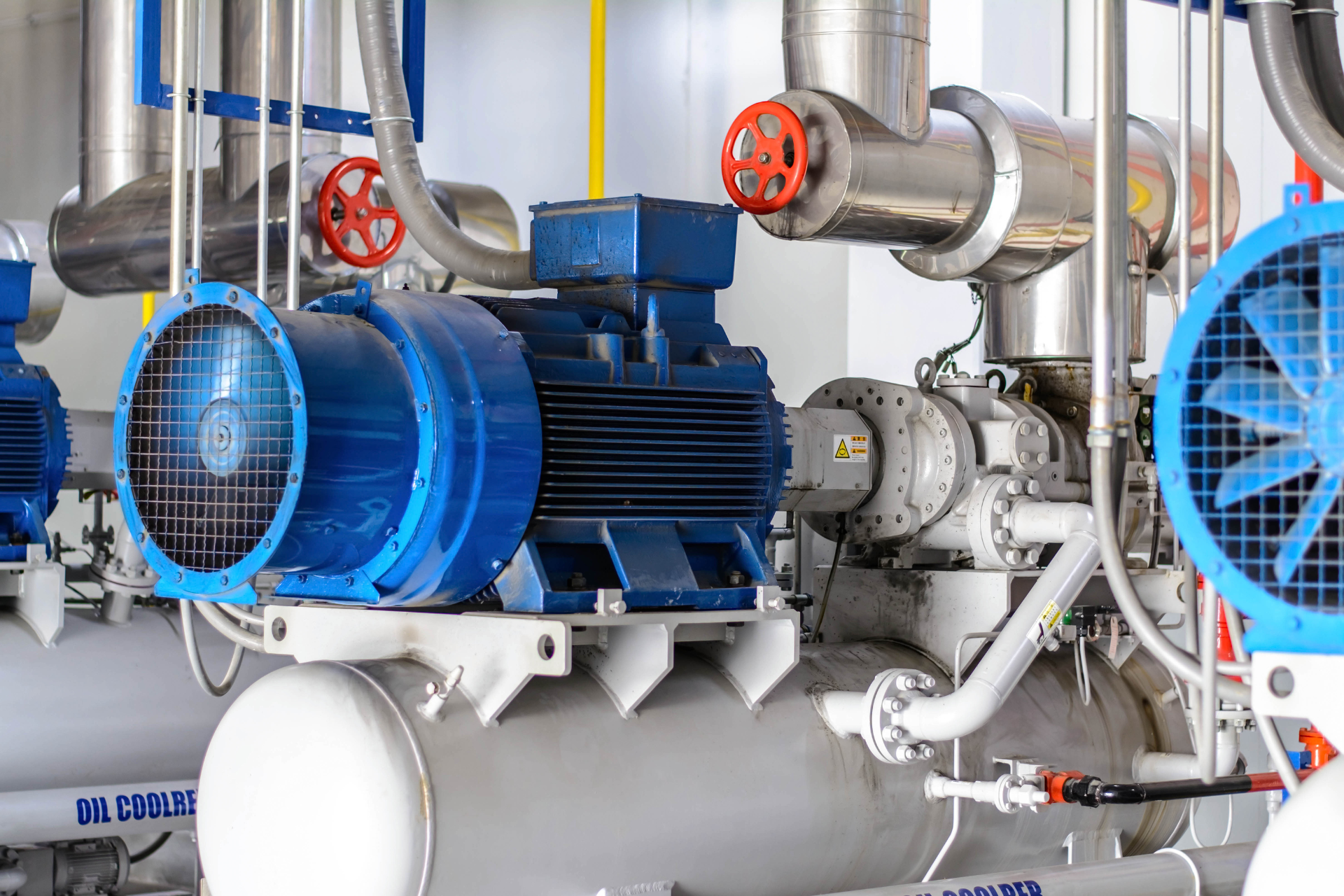 A room with a lot of pipes and fans in it