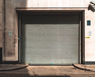 a garage door is closed on the side of a building .