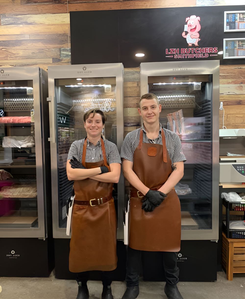 Two People in Aprons Are Standing Next to Each Other in a Butcher Shop — LZH Butchers in Bungalow, QLD