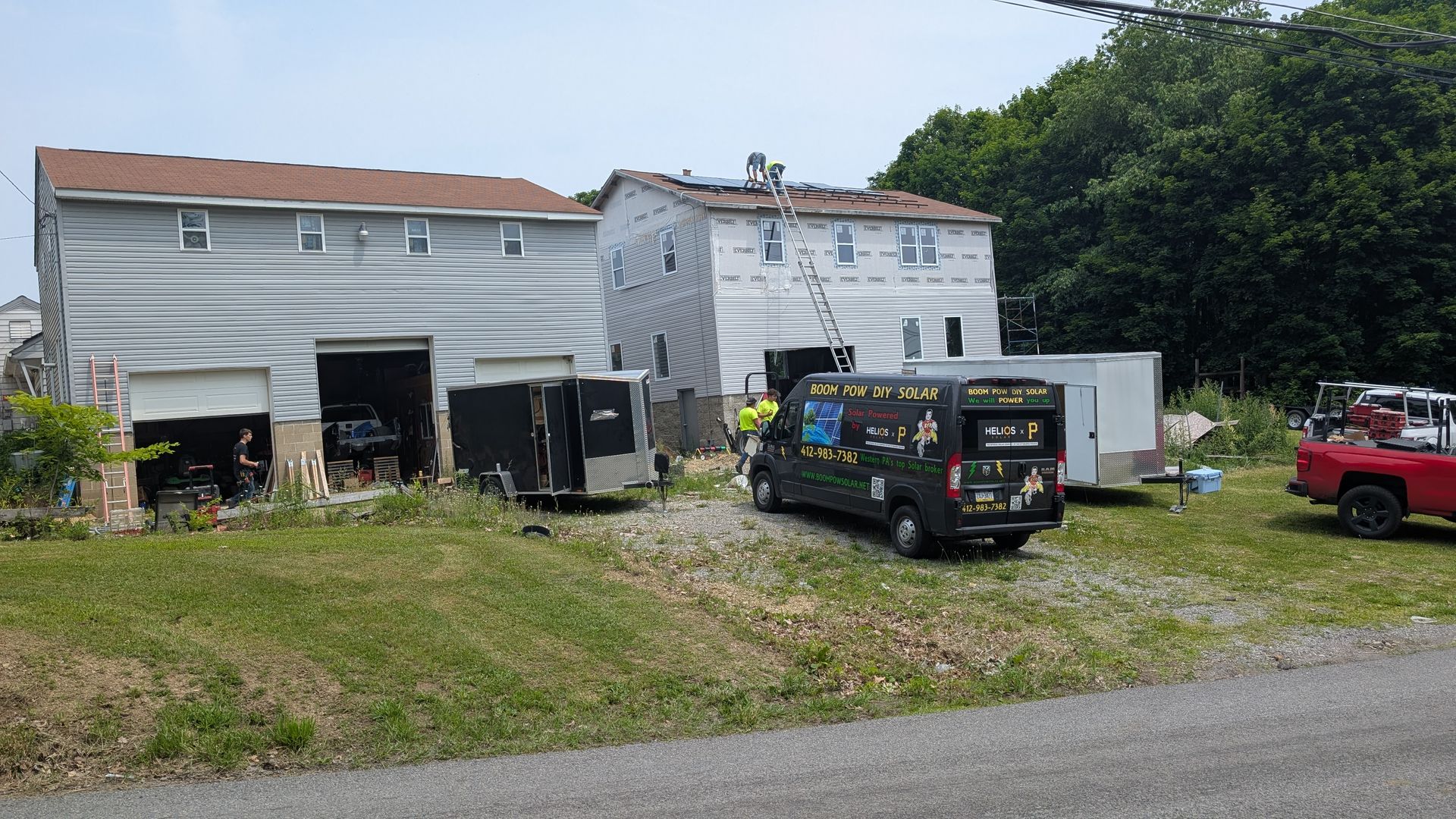 A black van is parked in front of a house.