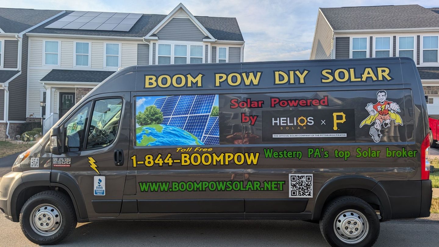 A boom pow diy solar van is parked in front of a house.