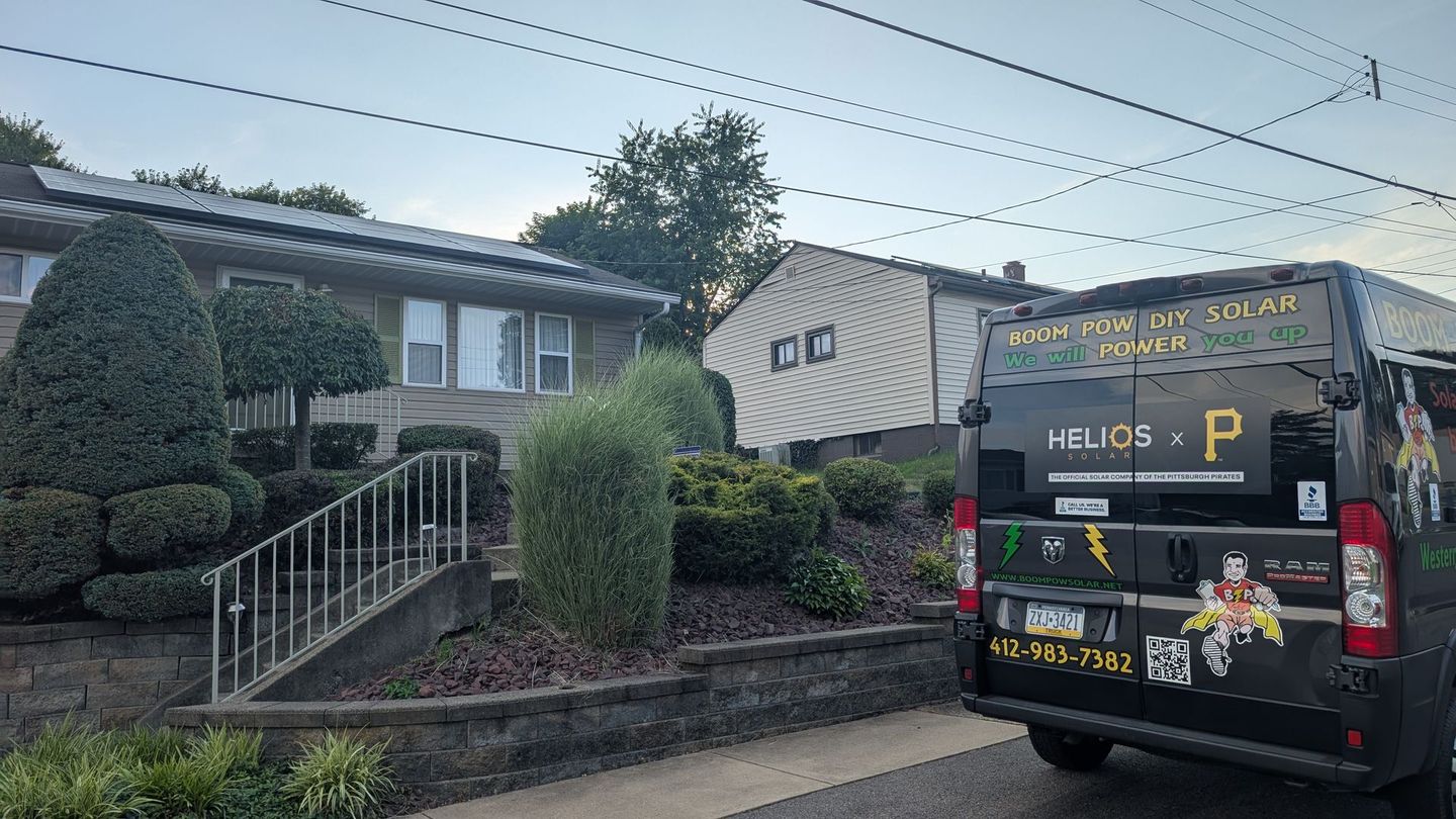 A black van is parked in front of a house.