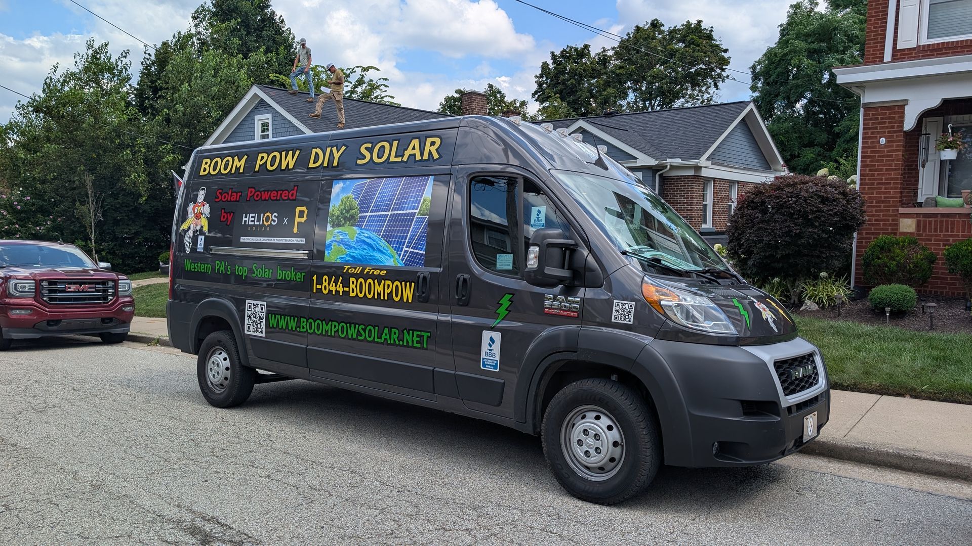 Dark van parked on a street with 