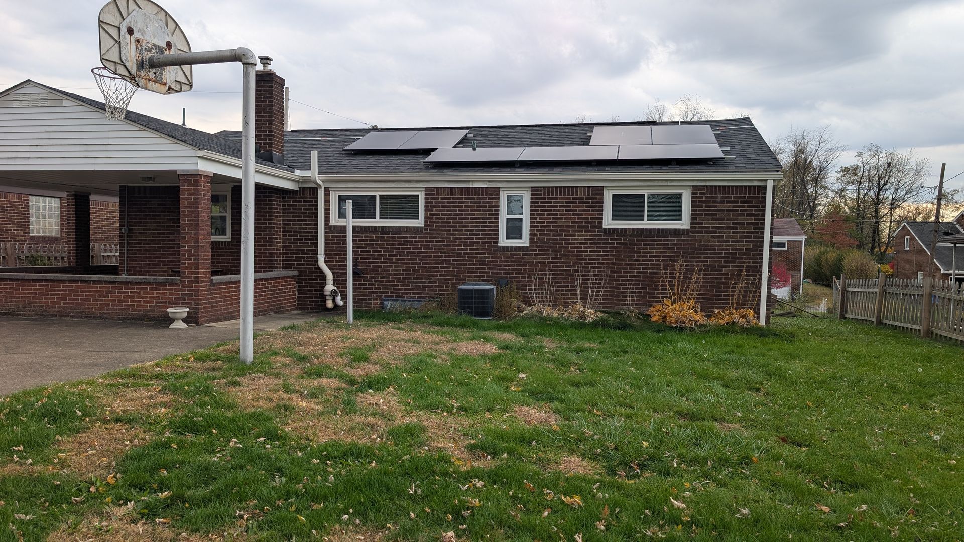Backyard of a house with solar panels on the roof