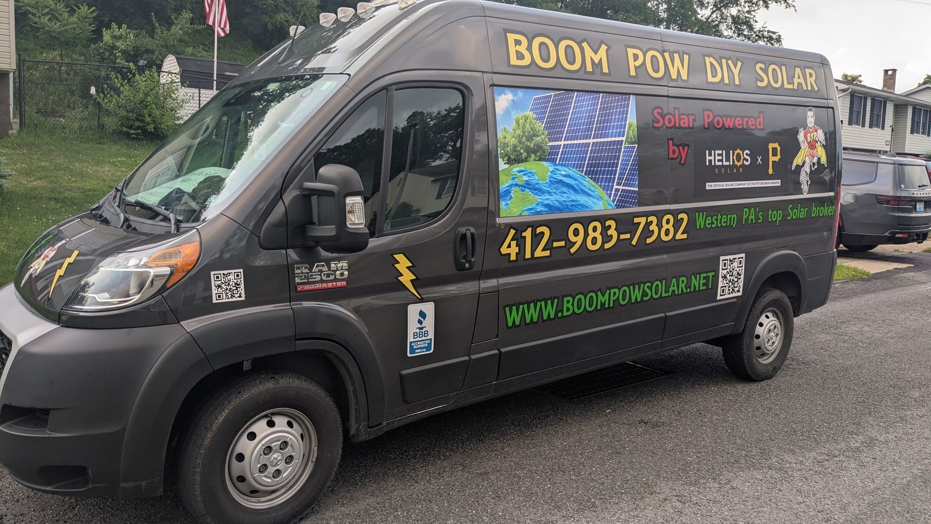 A boom pow diy solar van is parked on the side of the road.