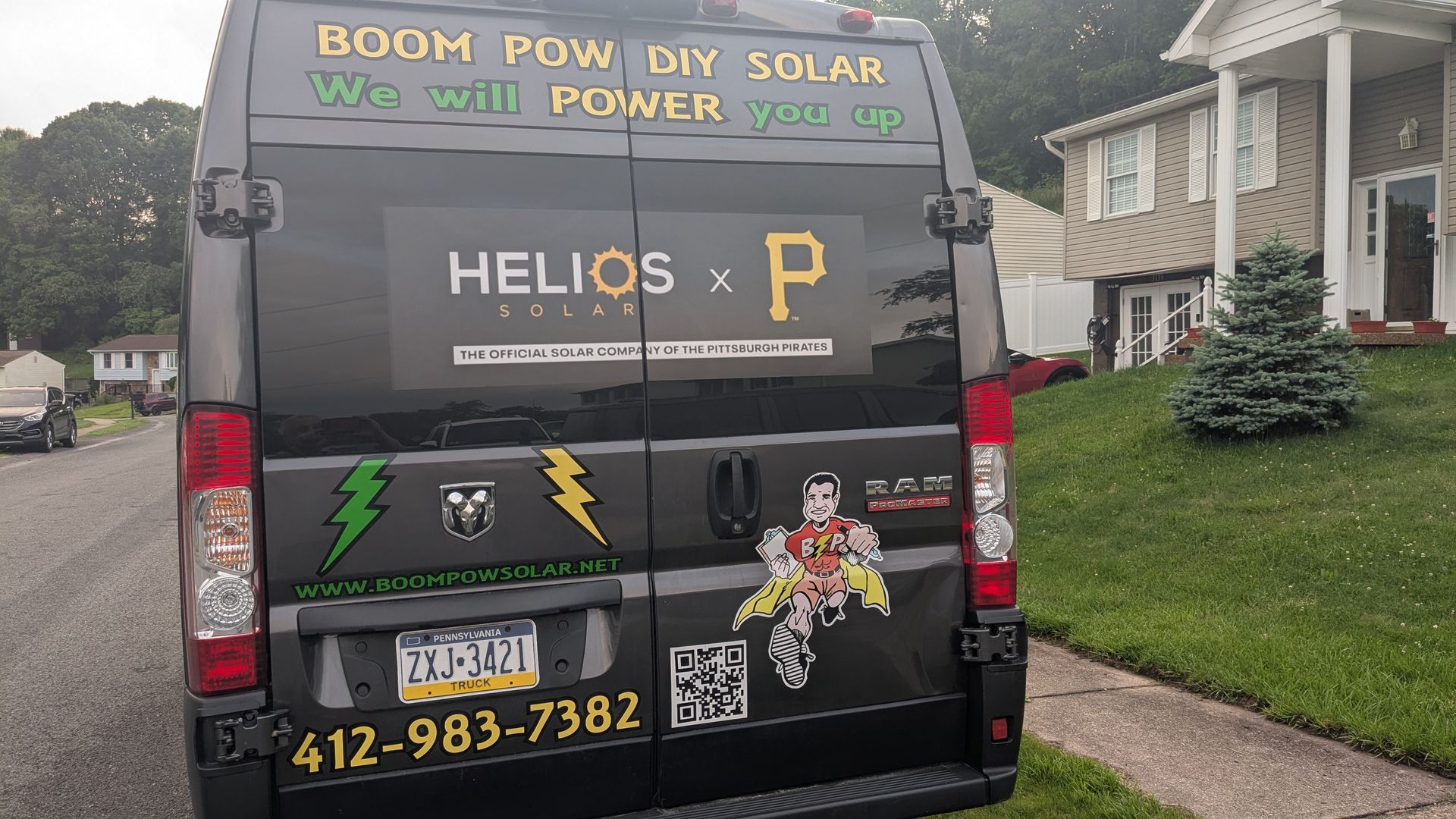 A van that says helios x p is parked in front of a house