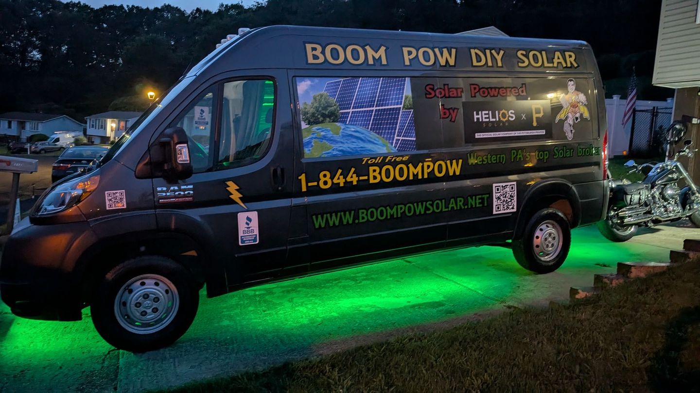 A black van that says boom pow diy solar on it