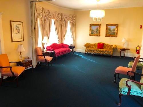 A living room with a couch and chairs in it