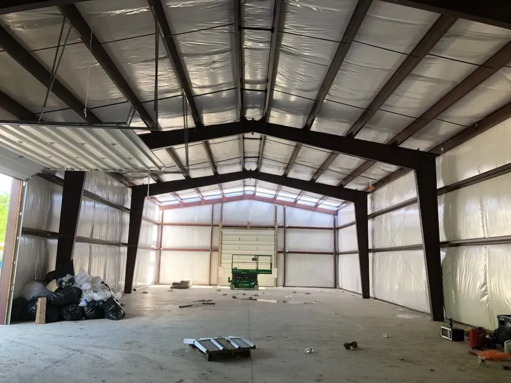 A large warehouse with a roof that is covered in insulation.