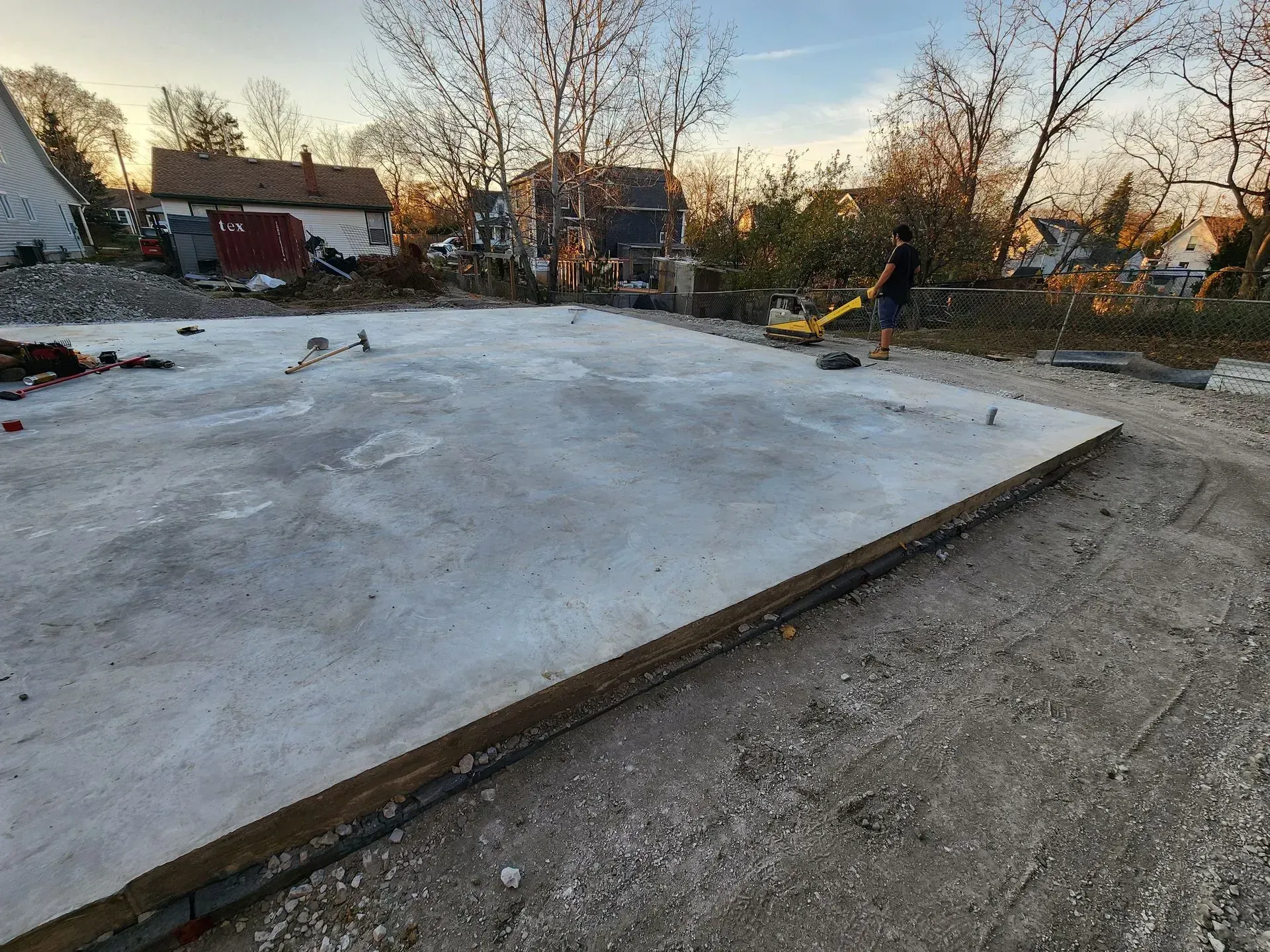 A large concrete slab is sitting on top of a dirt road.