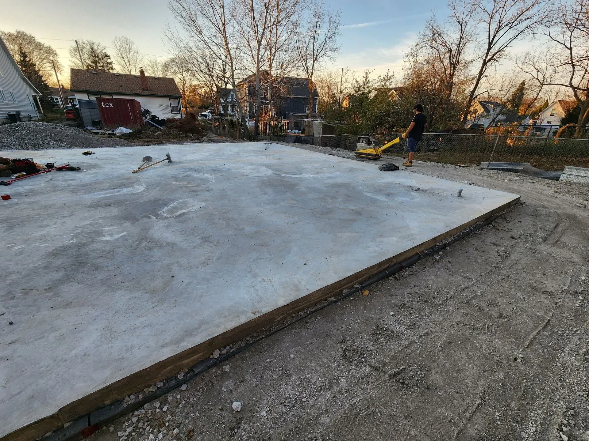 A large concrete slab is sitting on top of a dirt road.