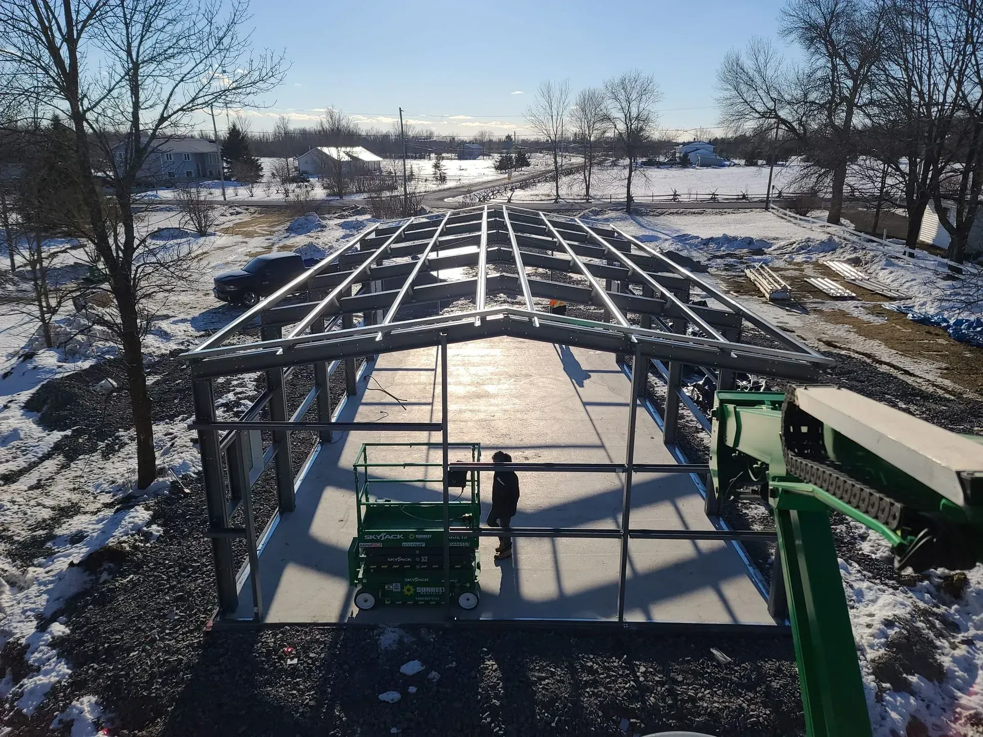 An aerial view of a building under construction in the snow