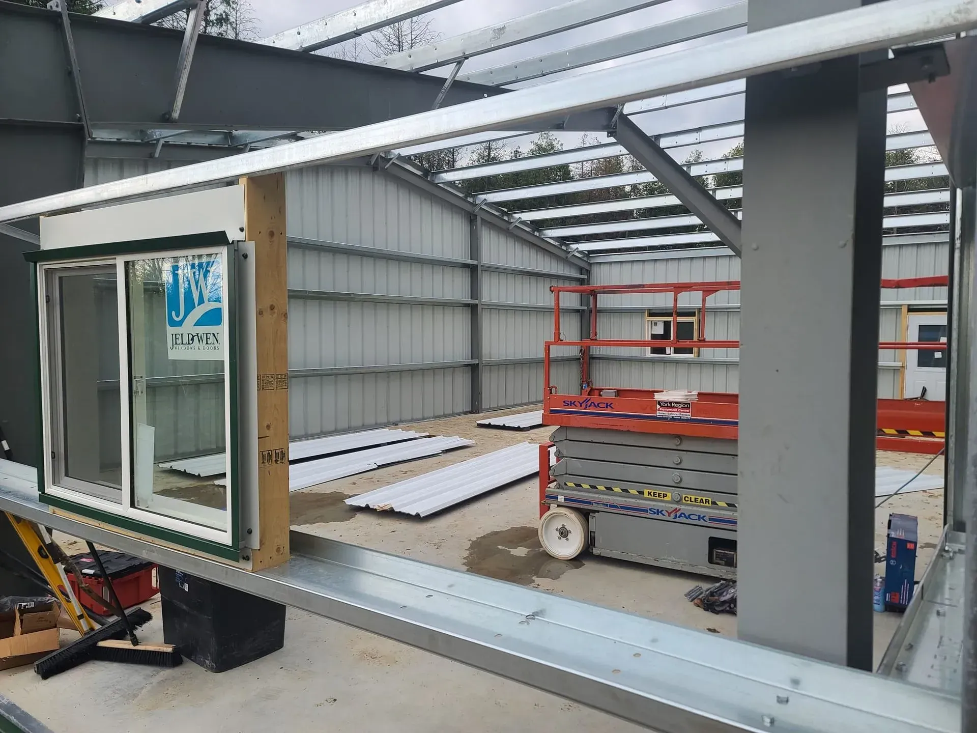 A window is being installed in a building under construction.