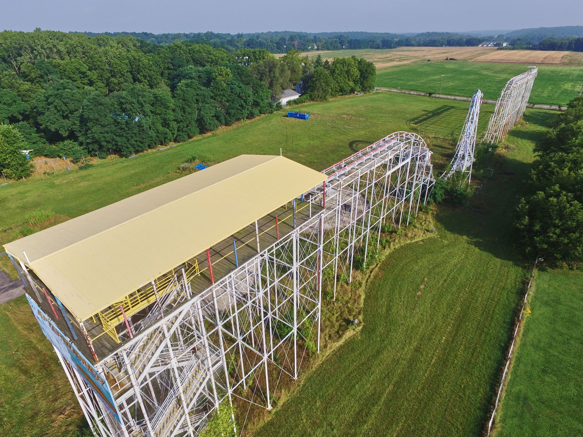 An aerial view of a roller coaster in a field.