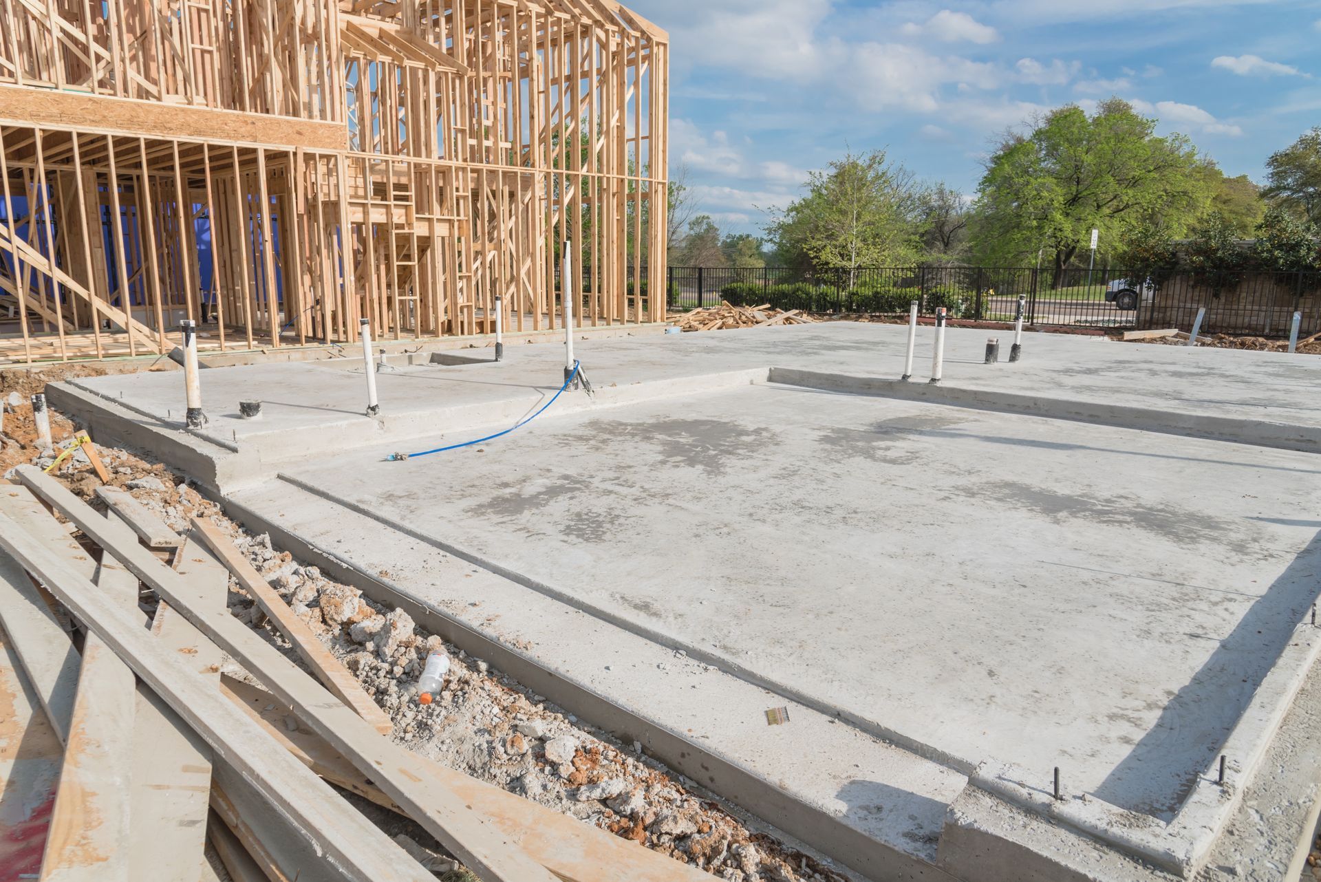 A house is being built with a concrete foundation.