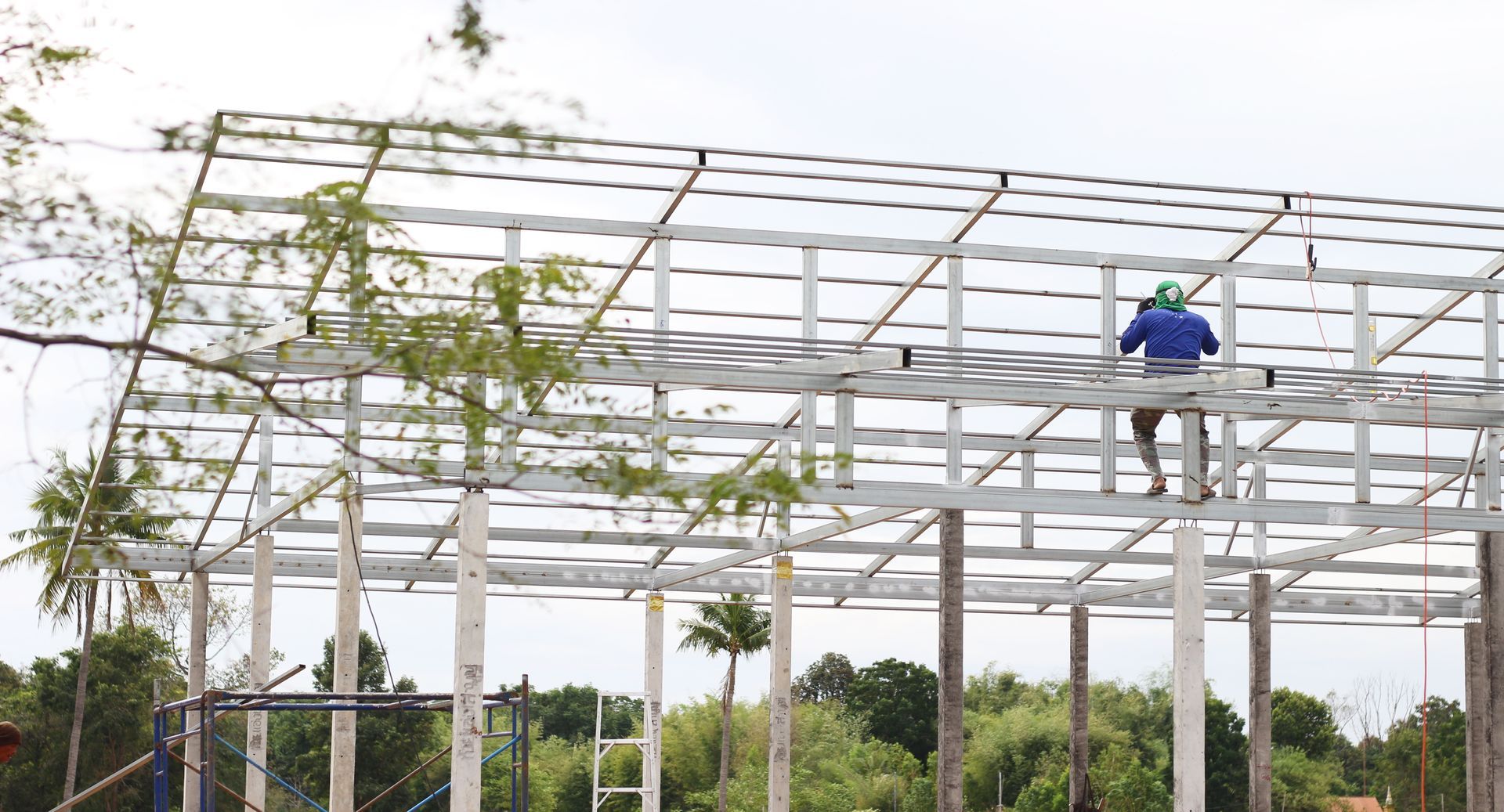 A man is standing on top of a metal structure.