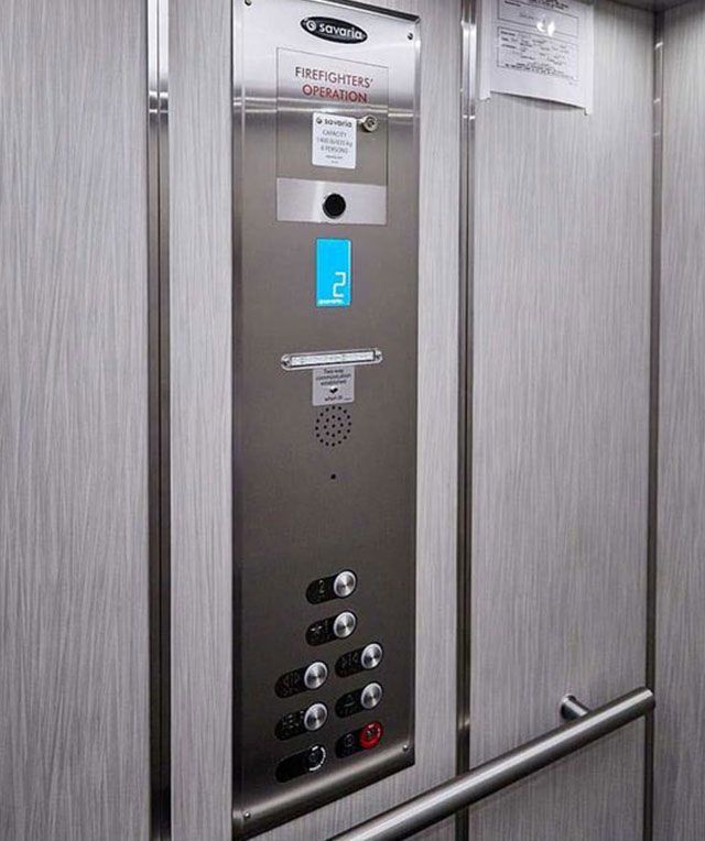 A Close up Of a Stainless Steel Elevator Control Panel — Master Lifts Cairns in Cairns, QLD