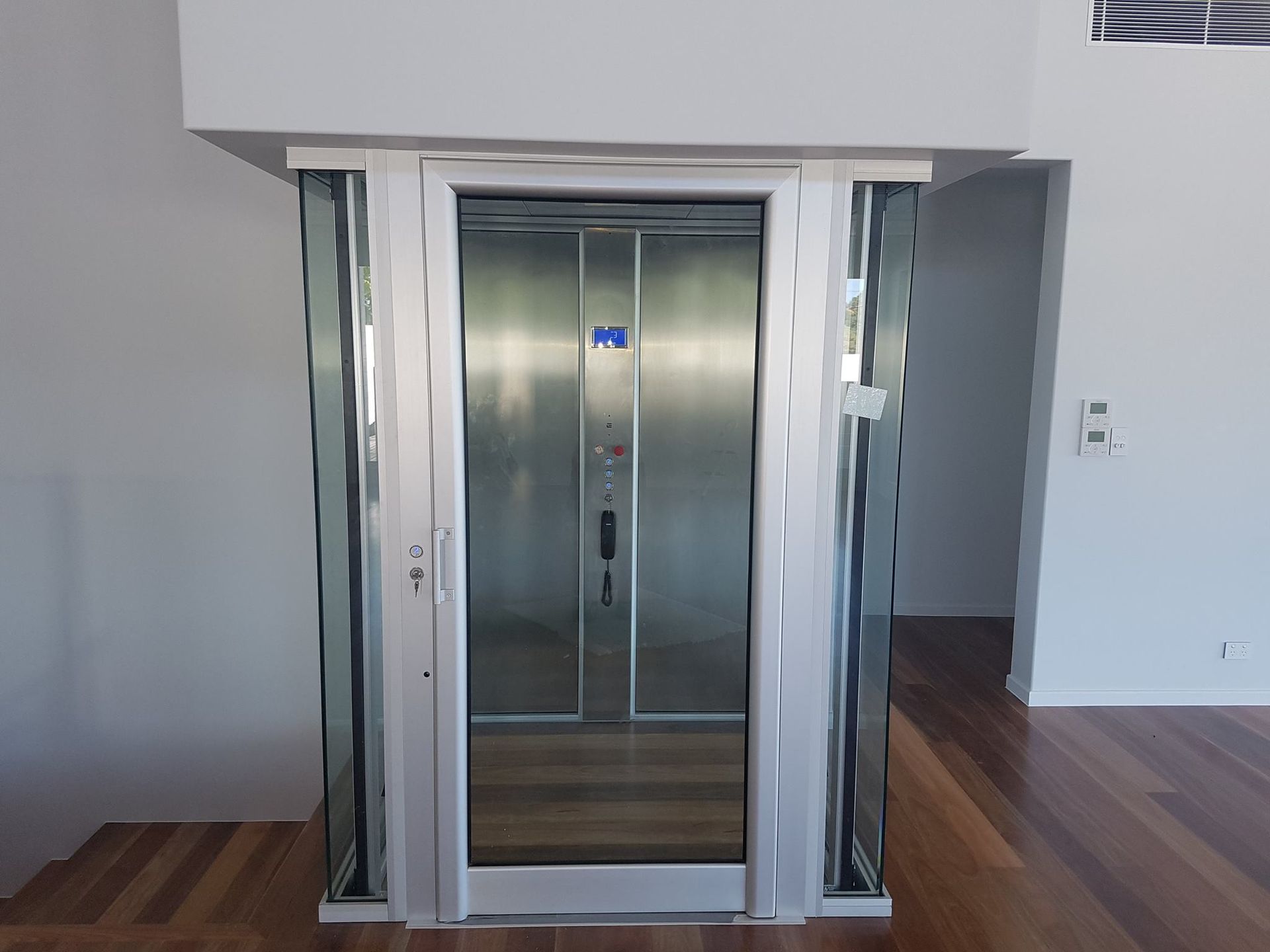 A Stainless Steel Elevator with A Glass Door — Master Lifts Cairns in Cairns, QLD