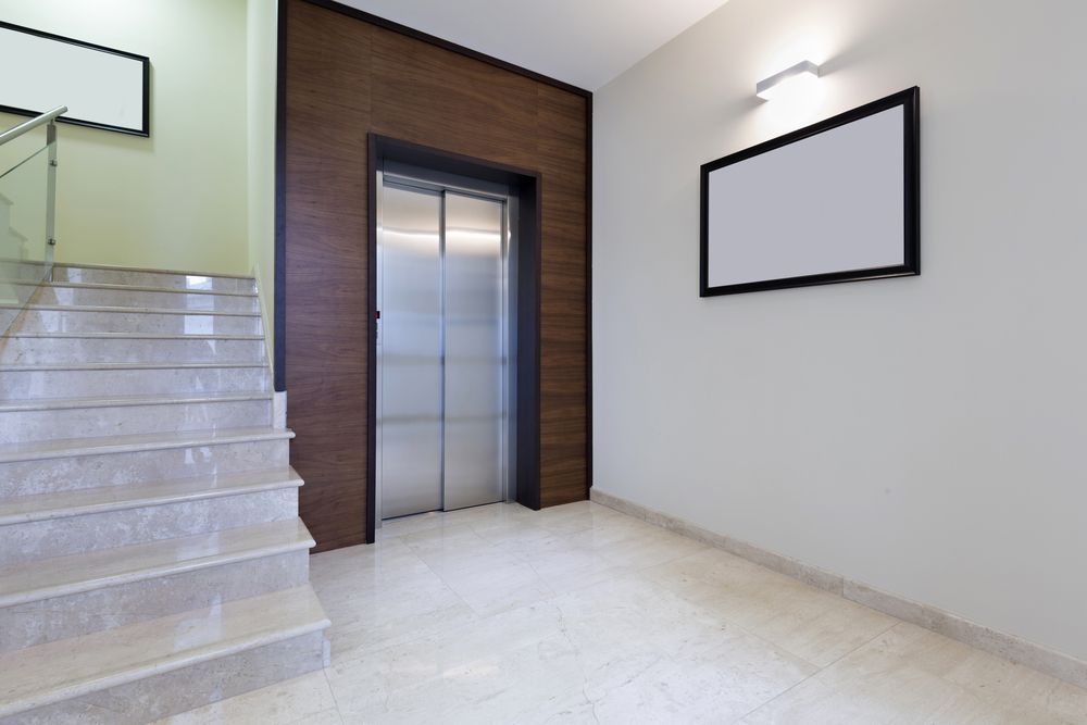 A Hallway with Stairs and An Elevator in A Building — Master Lifts Cairns in Cairns, QLD