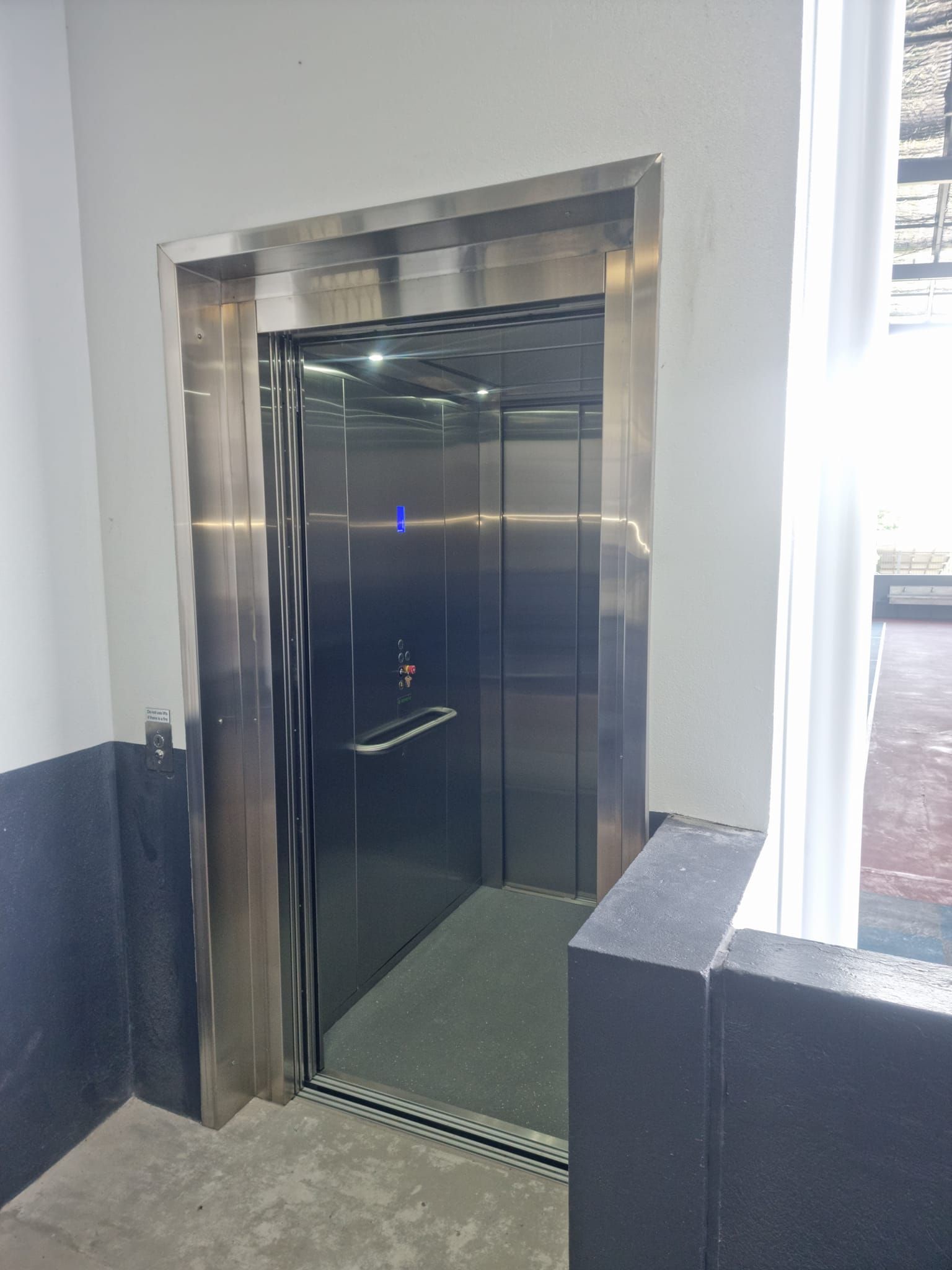 A Stainless Steel Elevator Is Sitting in A Building — Master Lifts Cairns in Cairns, QLD