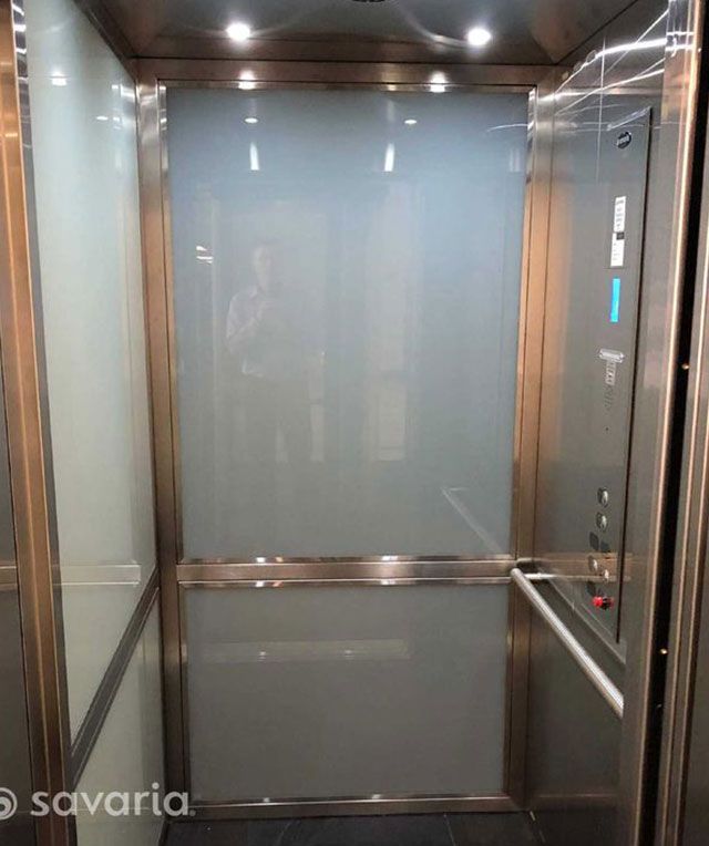 A Stainless Steel Elevator with A Glass Door — Master Lifts Cairns in Cairns, QLD